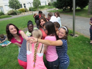 Some students trying to untangle themselves from the "human knot" (a game we played) this afternoon. It proved to be quite a challenge and a great way to review some vocabulary like "over", "under", and "through"!